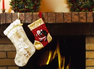 Two stockings hanging from the fireplace mantle