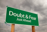 road sign reading doubt and fear with dark clouds in the background