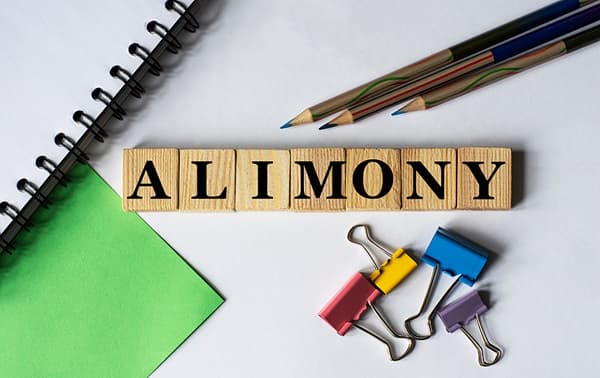 Alimony spelled with wooden tiles Alimony spelled with wooden tiles