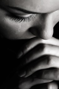 Betrayed woman looking down and crying