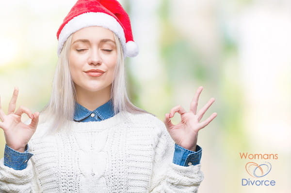 Woman in a Santa Hat relaxes with yogo so she can manage her holiday stress Woman in a Santa Hat relaxes with yogo so she can manage her holiday stress