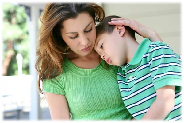 Mother comforting her son to help him deal with his emotions about his parent's divorce Mother comforting her son to help him deal with his emotions about his parent's divorce