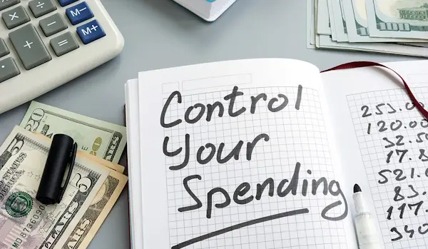 Control Your Spending written in notebook