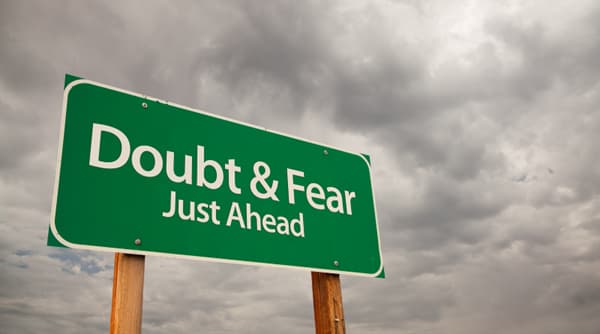 road sign reading doubt and fear with dark clouds in the background road sign reading doubt and fear with dark clouds in the background