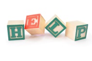 The word 'HELP' spelled out with wooden blocks symbolic of the challenges of divorced parenting