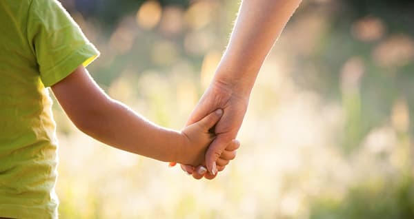 mom holding son's hand