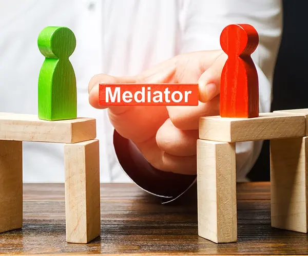 Blocks symbolizing how a mediator help form a bridge between 2 opposing parties Mediator guiding mediation in divorce