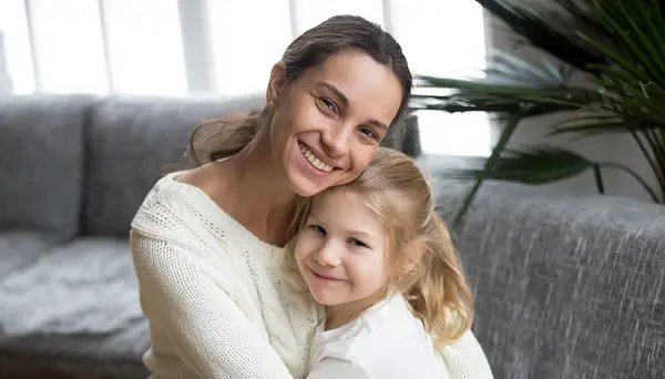 mom hugging daughter