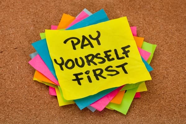 Sticky note on cork-board that says to Pay Yourself First Pay yourself first sticky note