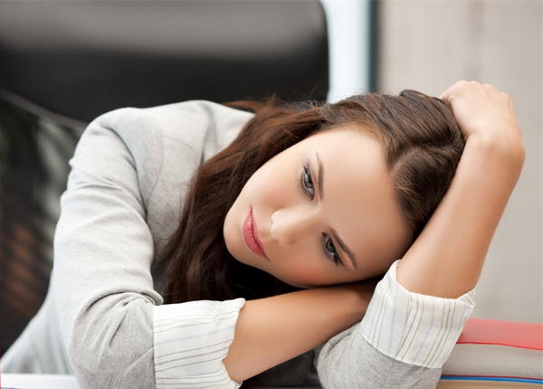 Woman dealing with insecurities after divorce and resting her head on her arm Insecure woman resting her head on her arm.