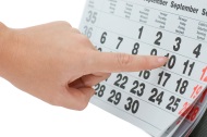 Woman's hand pointing to date on calendar Woman's hand pointing to date on calendar