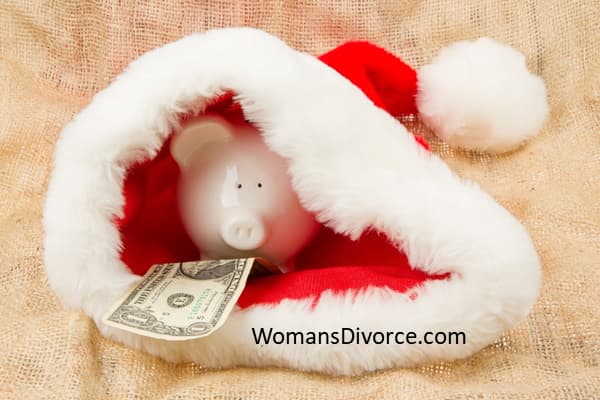 Budget friendly tips for how to afford Christmas after divorce. Cute piggy bank hiding in Santa's cap