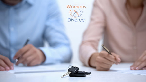 Couple signing a divorce settlement agreement dividing their debts and assets Dividing Debts