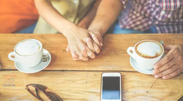 Couple holding hands who are ready to start dating again after divorce dating couple holding hands across table