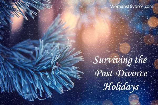 Closeup of pine branch with Christmas lights in the background