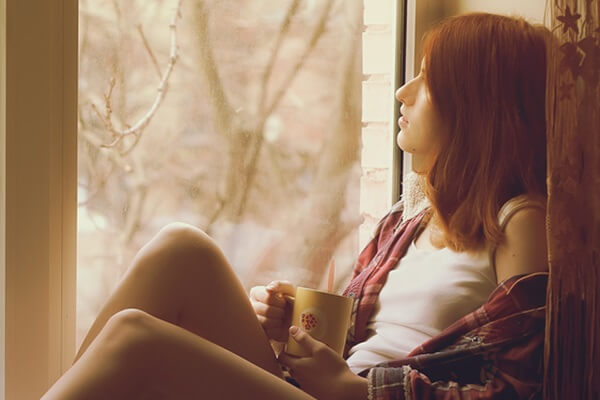 Teen gazing out window, worried about her parent's divorce Teen gazing out window, worried about her parent's divorce
