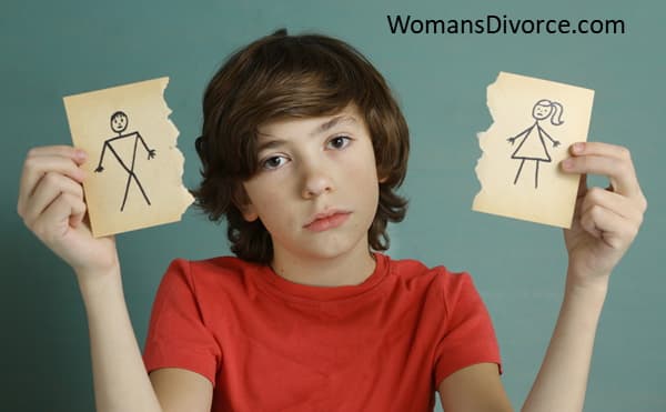 Boy holding a picture of stick figure parents torn apart showing how children are impacted by divorce. Boy holding a picture of stick figure parents torn apart showing how children are impacted by divorce.