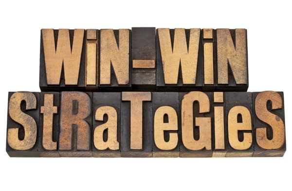 Wooden block letters spelling out Win-Win Strategies depicting divorce mediation tips and tricks for successful negotiations Wooden letters spelling out Win-Win Strategies depicting successful negotiation during mediation